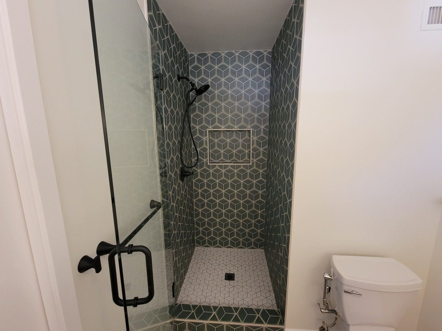 A bathroom with a shower and toilet in it