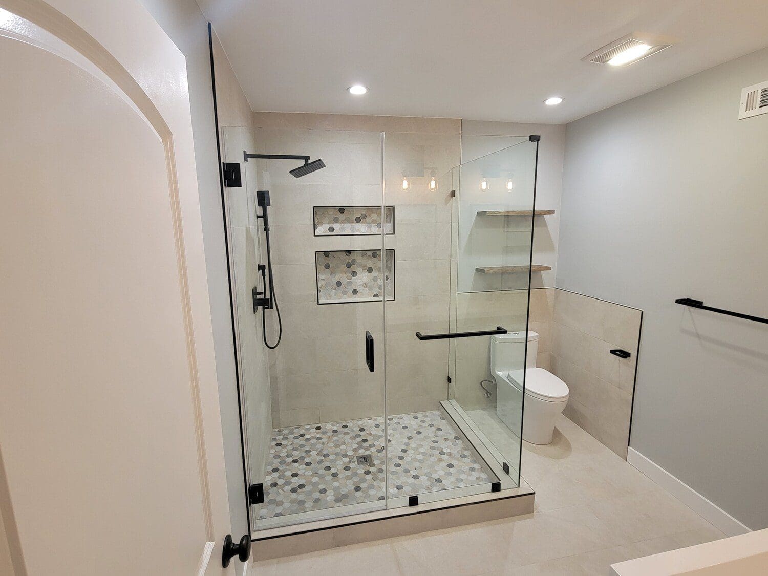 A bathroom with a shower and toilet in it