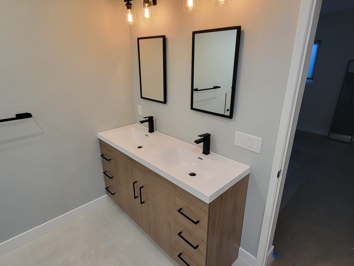 A bathroom with two sinks and mirrors.