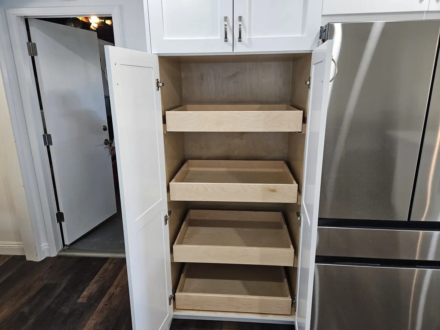 A kitchen with white cabinets and drawers in it