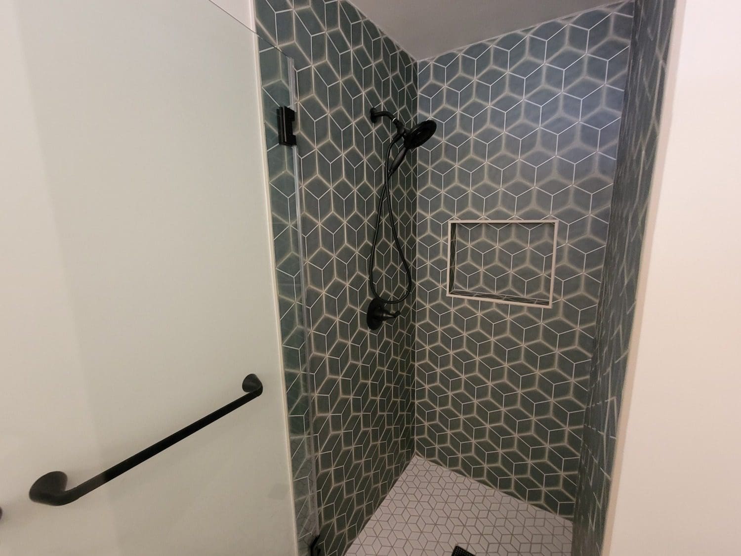 A bathroom with a shower and tiled walls.