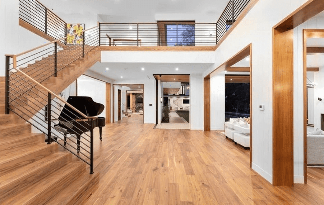 A large open floor plan with wood floors and white walls.