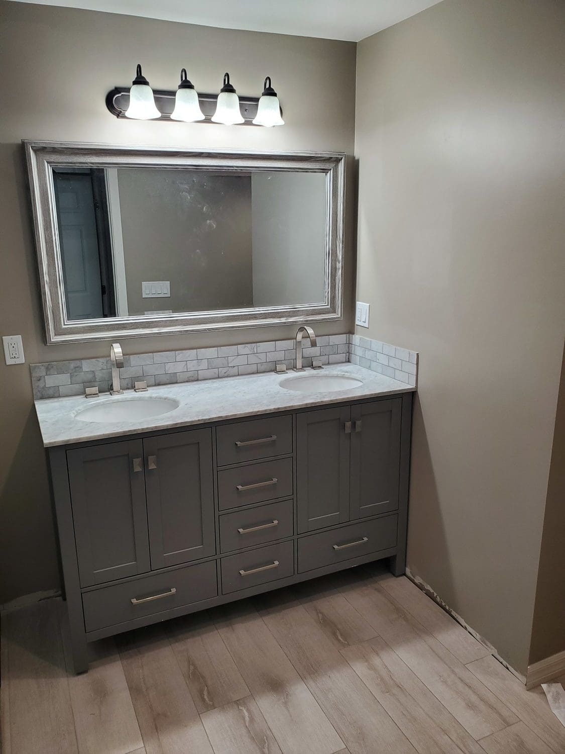 A bathroom with two sinks and a large mirror.