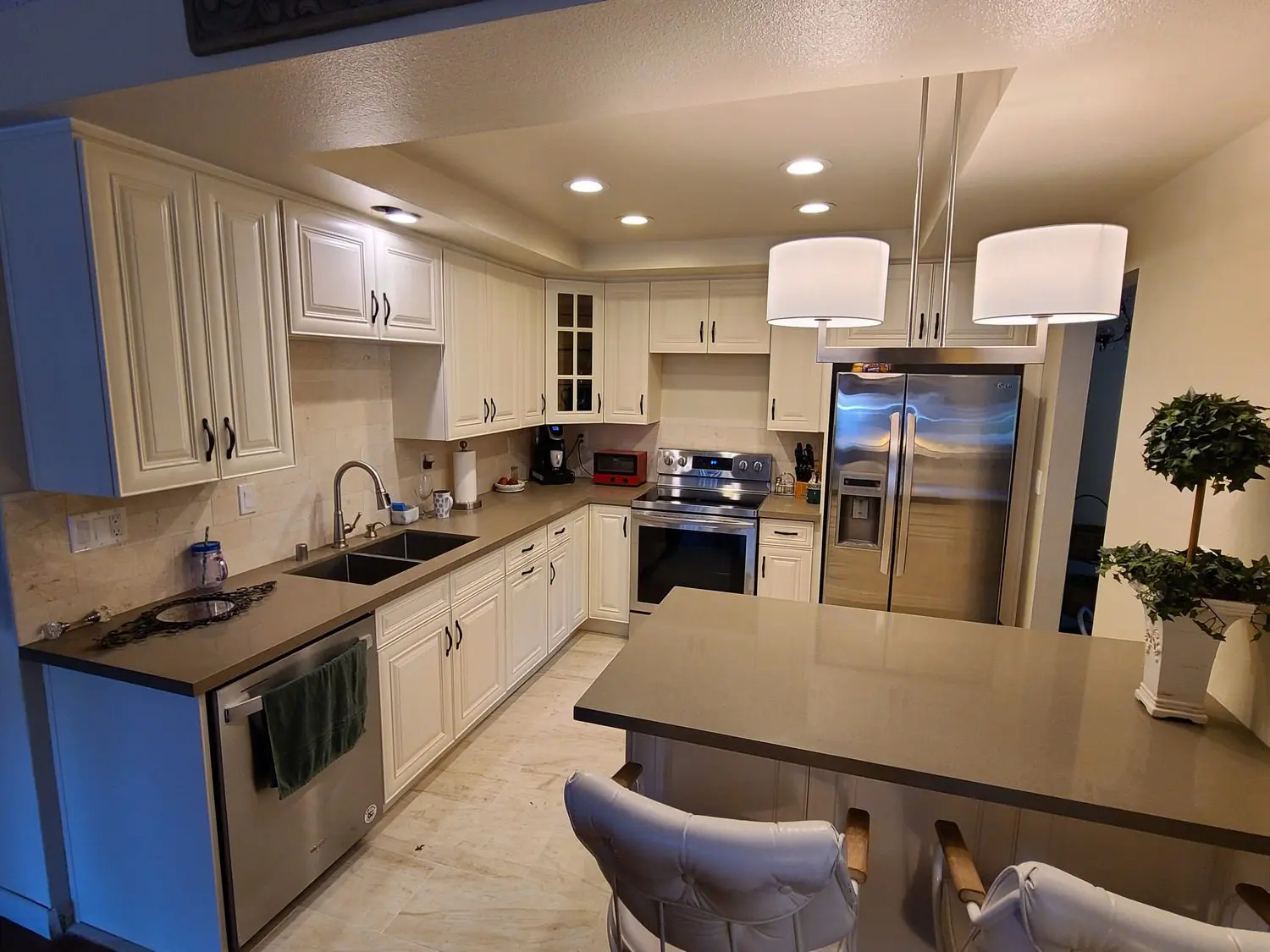 A kitchen with white cabinets and stainless steel appliances.