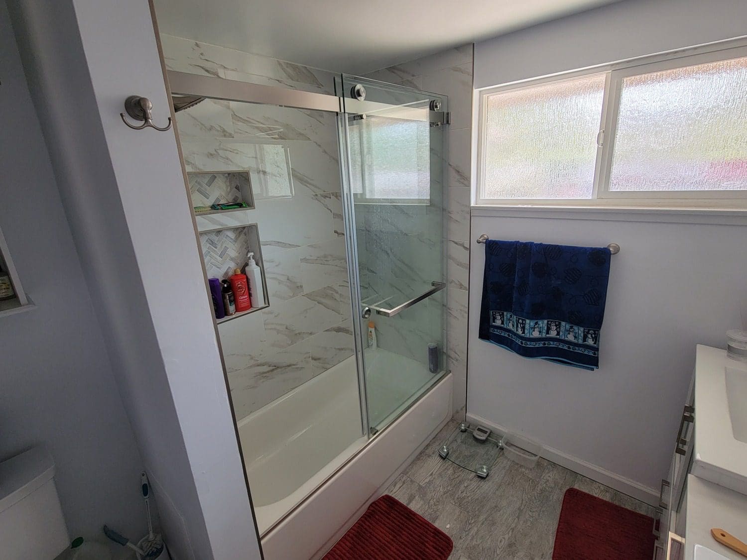 A bathroom with a tub and shower in it