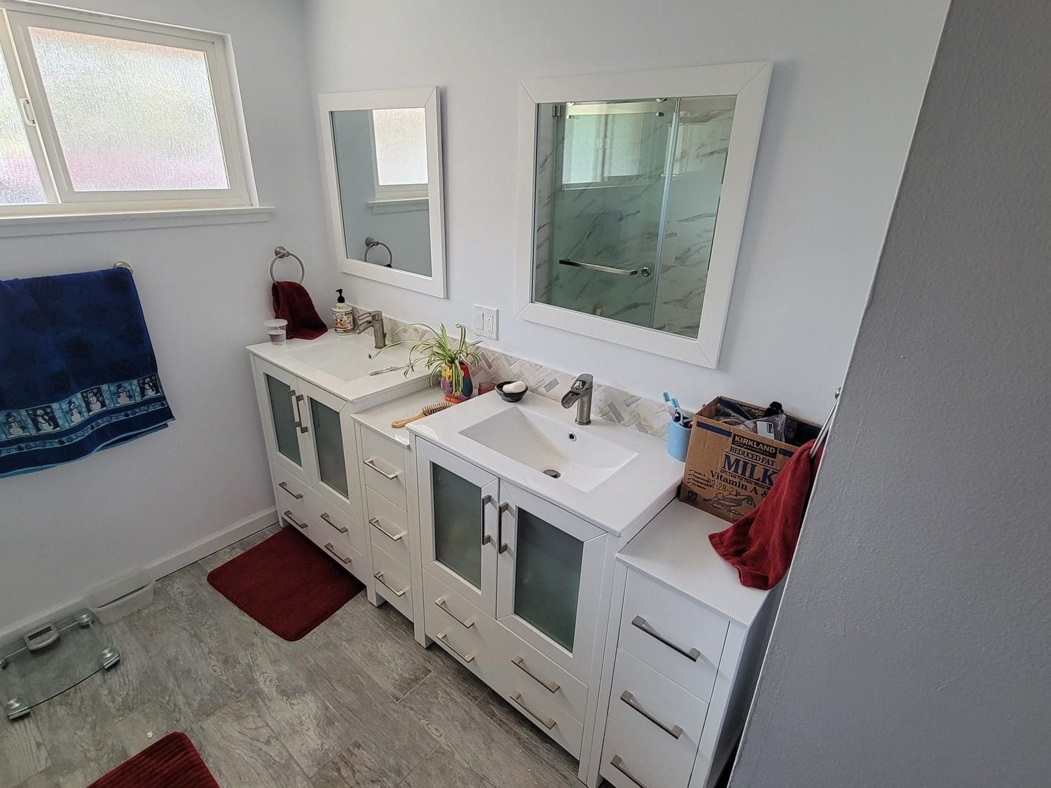 A bathroom with two sinks and mirrors.