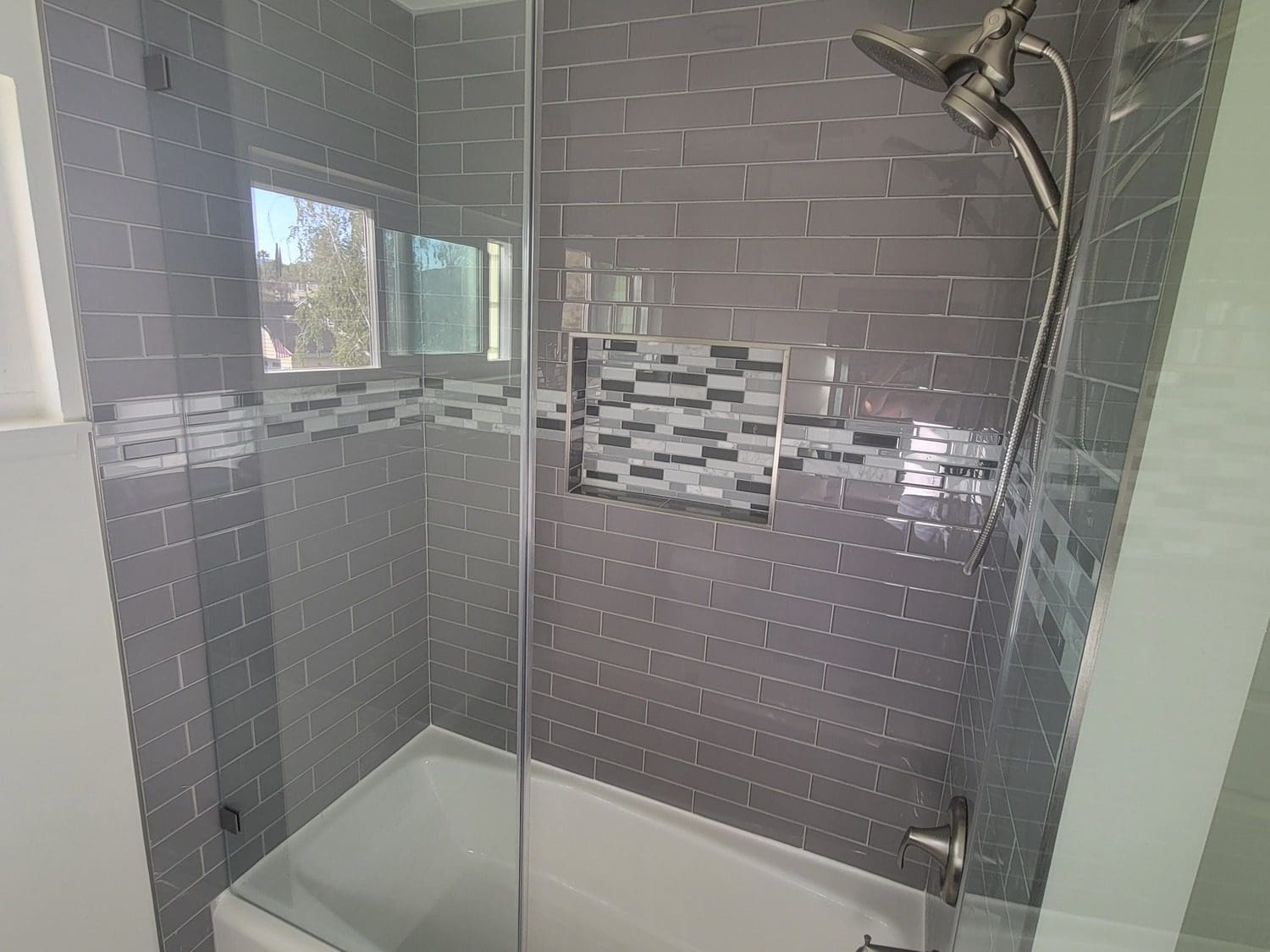 A bathroom with a shower and tub in it