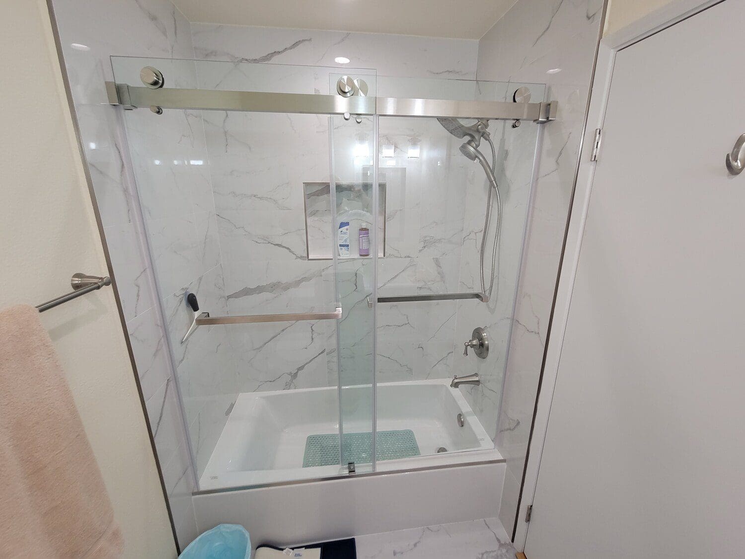 A bathroom with a shower and tub in it