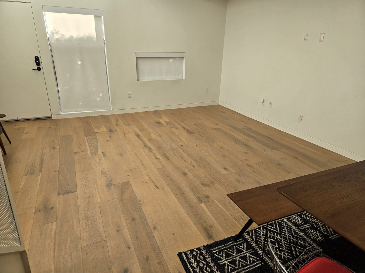 A room with wood floors and white walls.