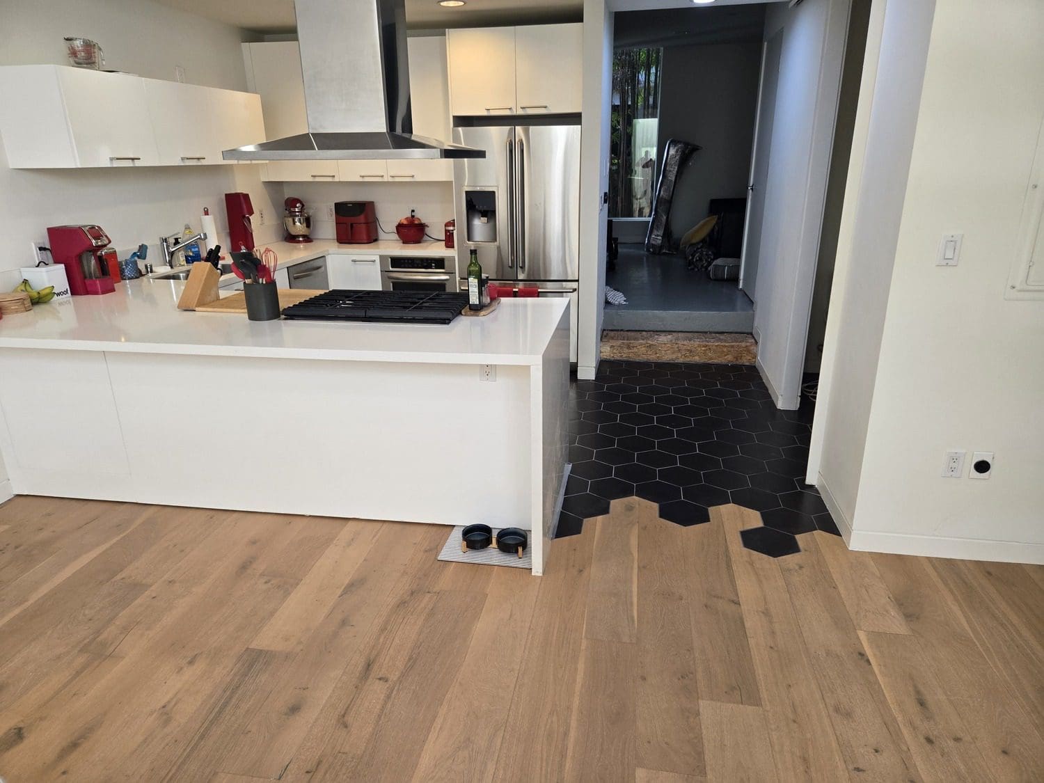 A kitchen with black and white tile floor