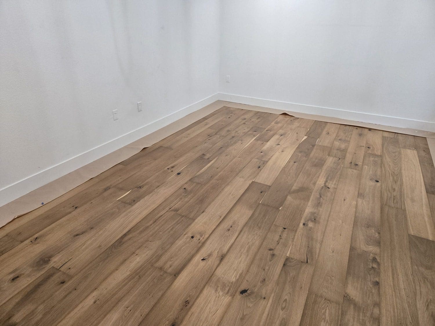 A room with wood floors and white walls.