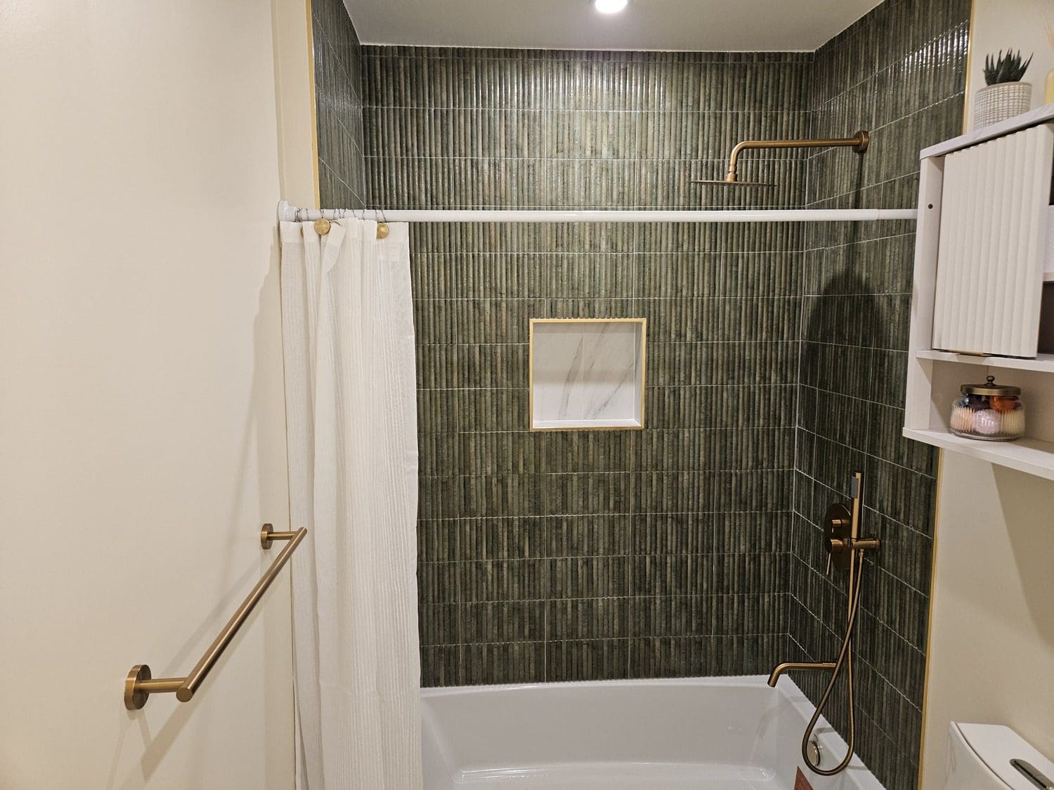 A bathroom with a shower, tub and toilet.