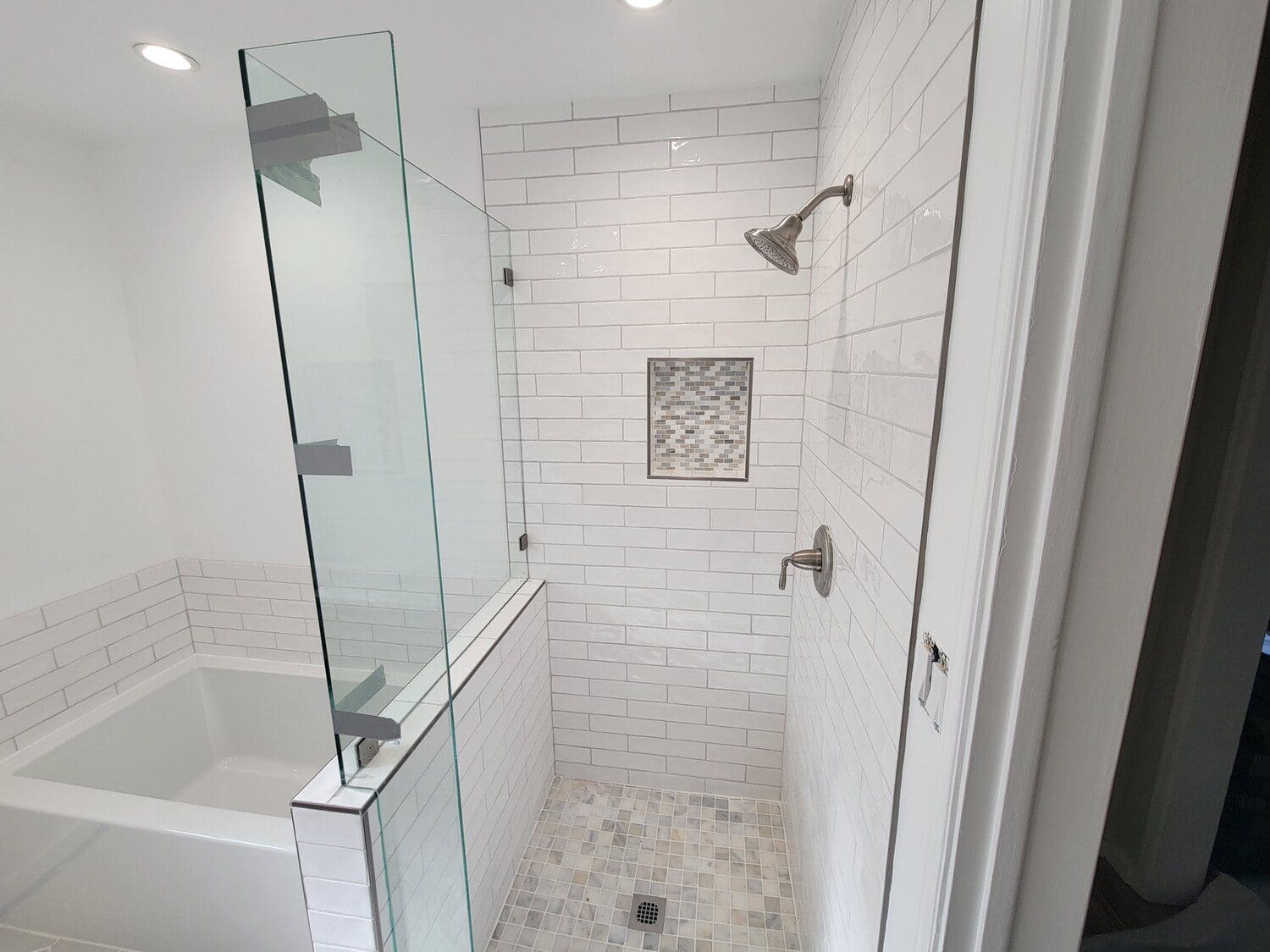 A bathroom with a shower and tub in it