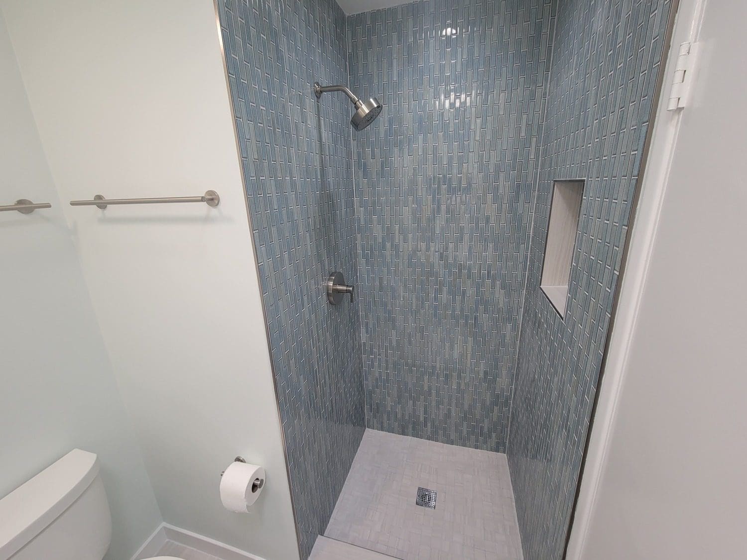 A bathroom with a shower and toilet in it