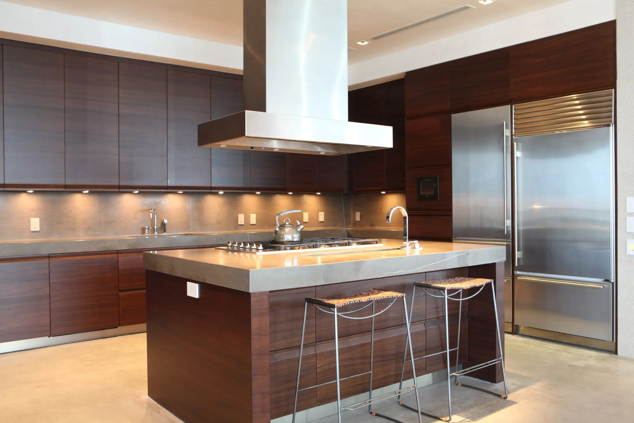 A kitchen with a large island and stainless steel appliances.