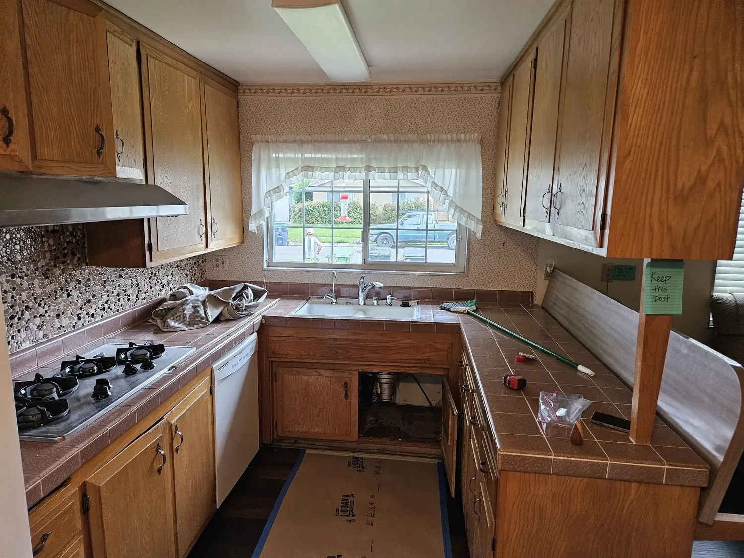 A kitchen with wooden cabinets and a window.