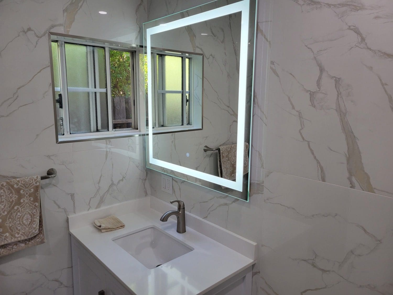 A bathroom with a sink and mirror in it