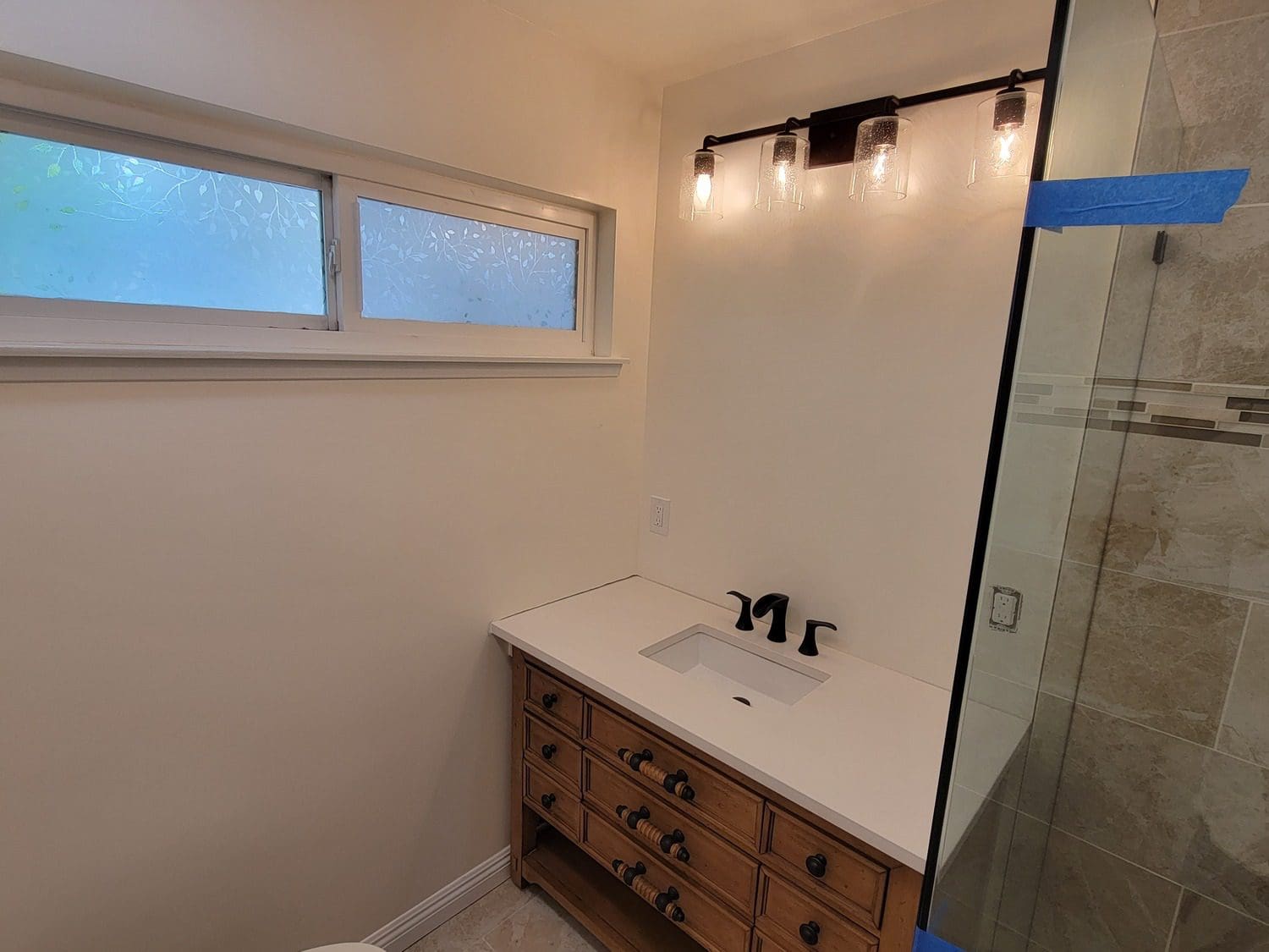 A bathroom with a sink and mirror in it