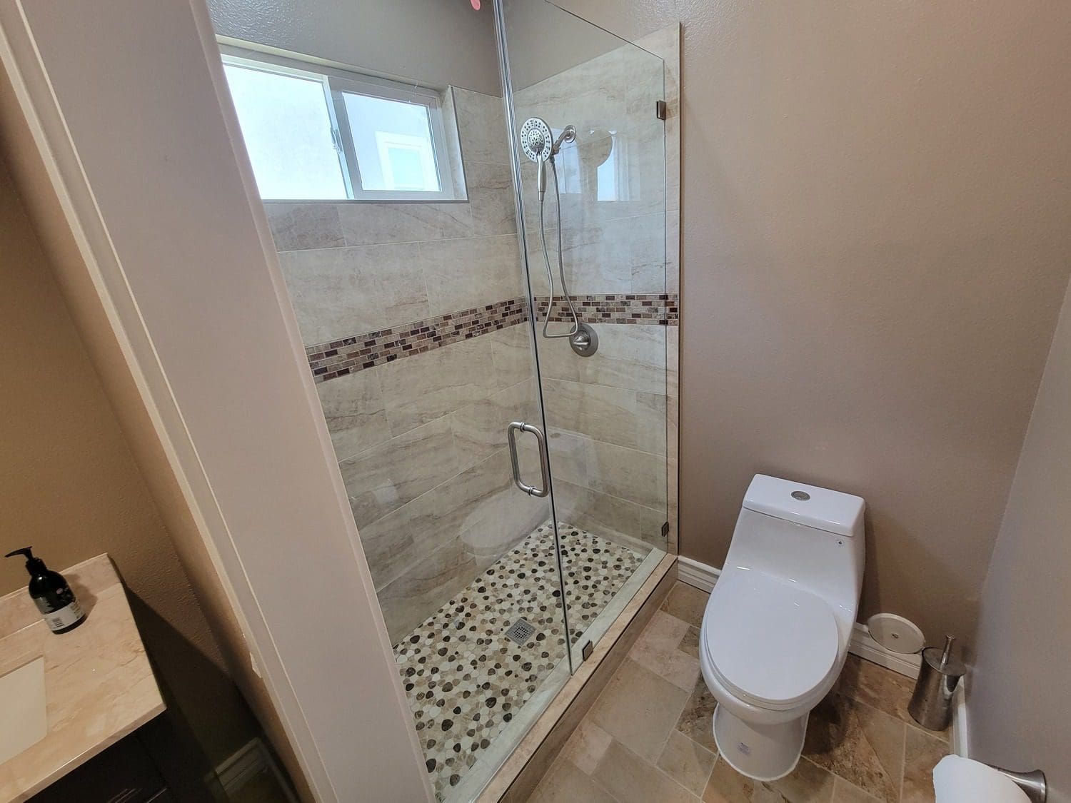 A bathroom with a toilet and shower in it