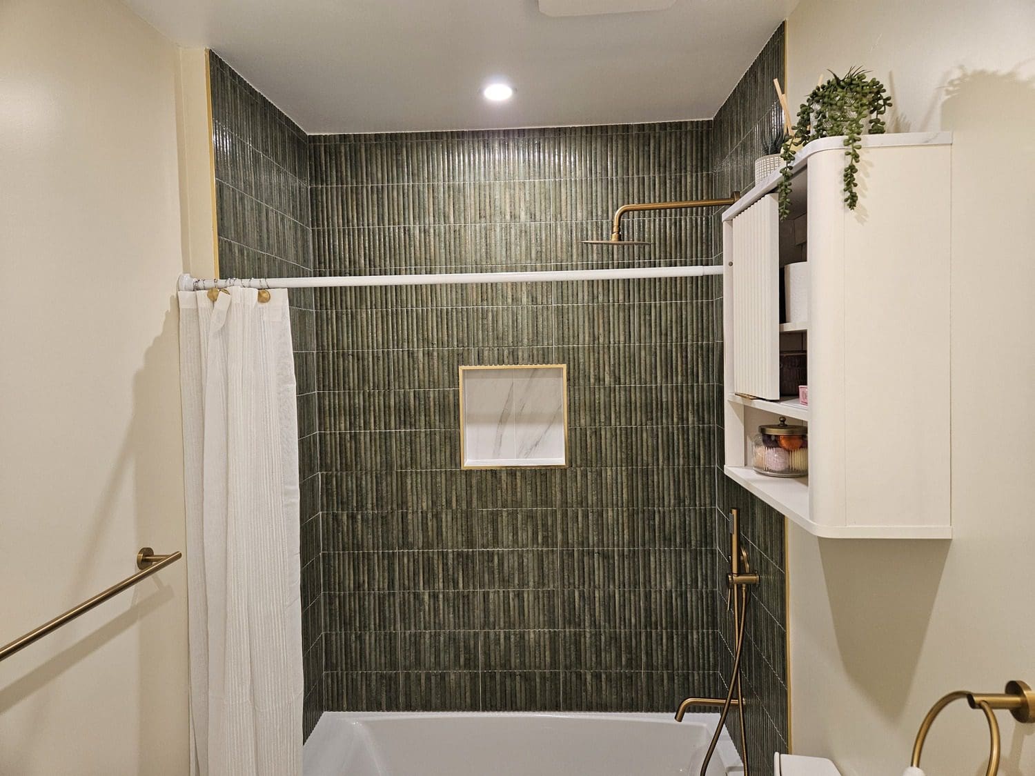 A bathroom with a tub, shower and toilet.