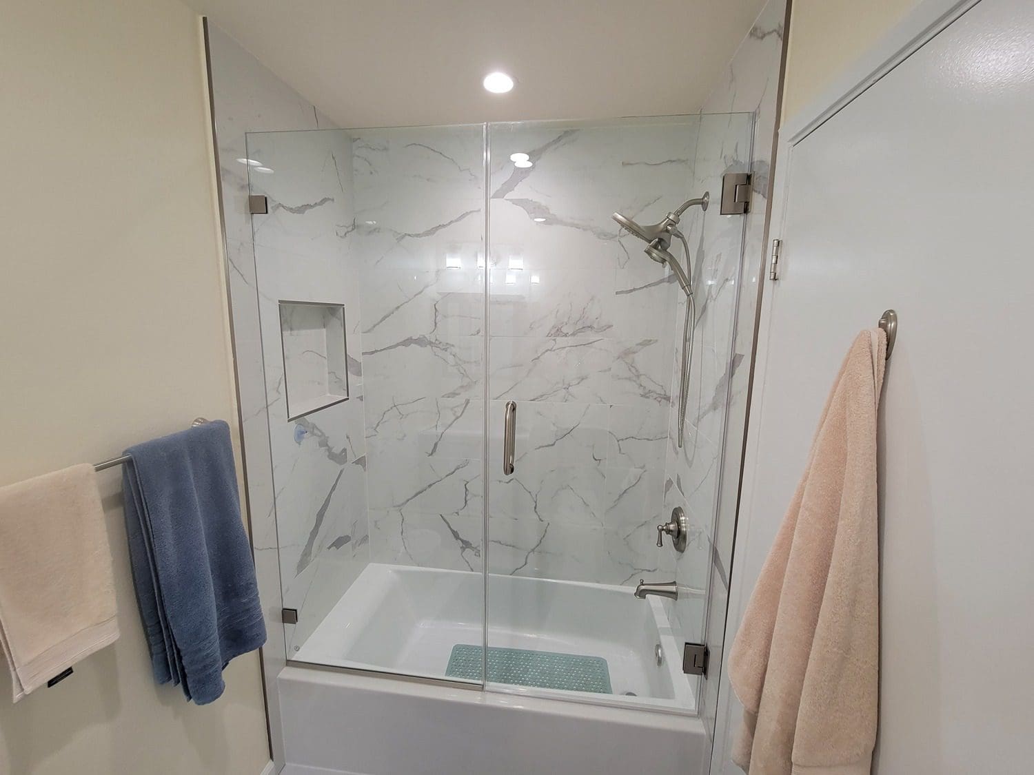 A bath tub and shower in a bathroom.