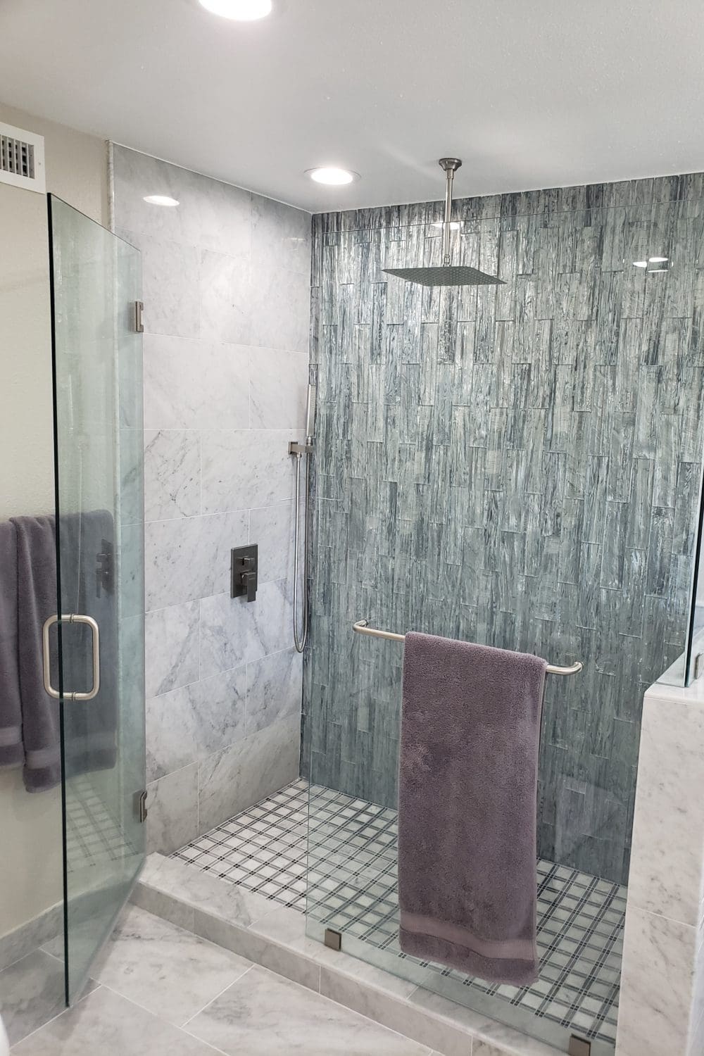 A bathroom with a shower and tiled walls.