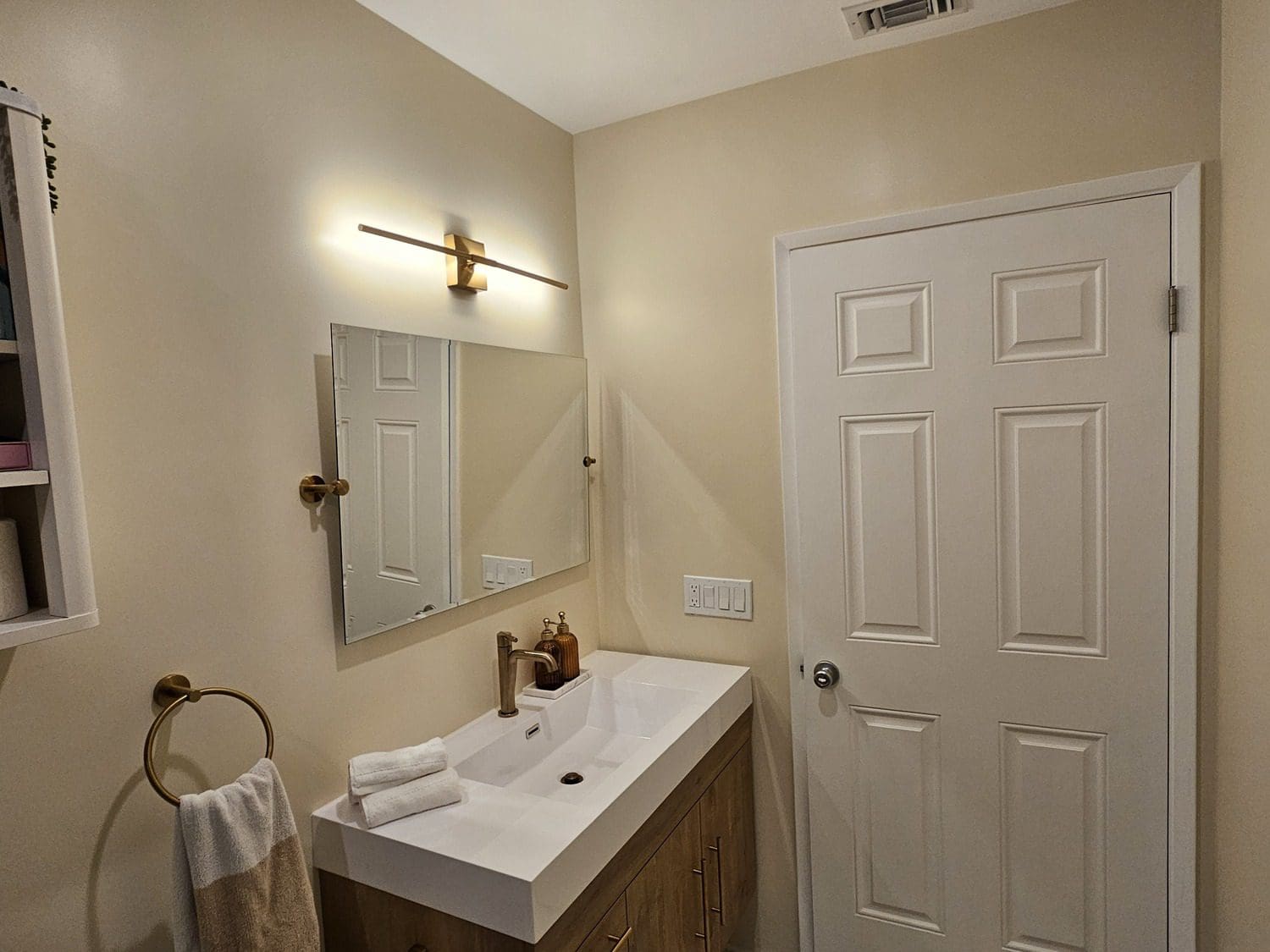 A bathroom with a sink and mirror in it