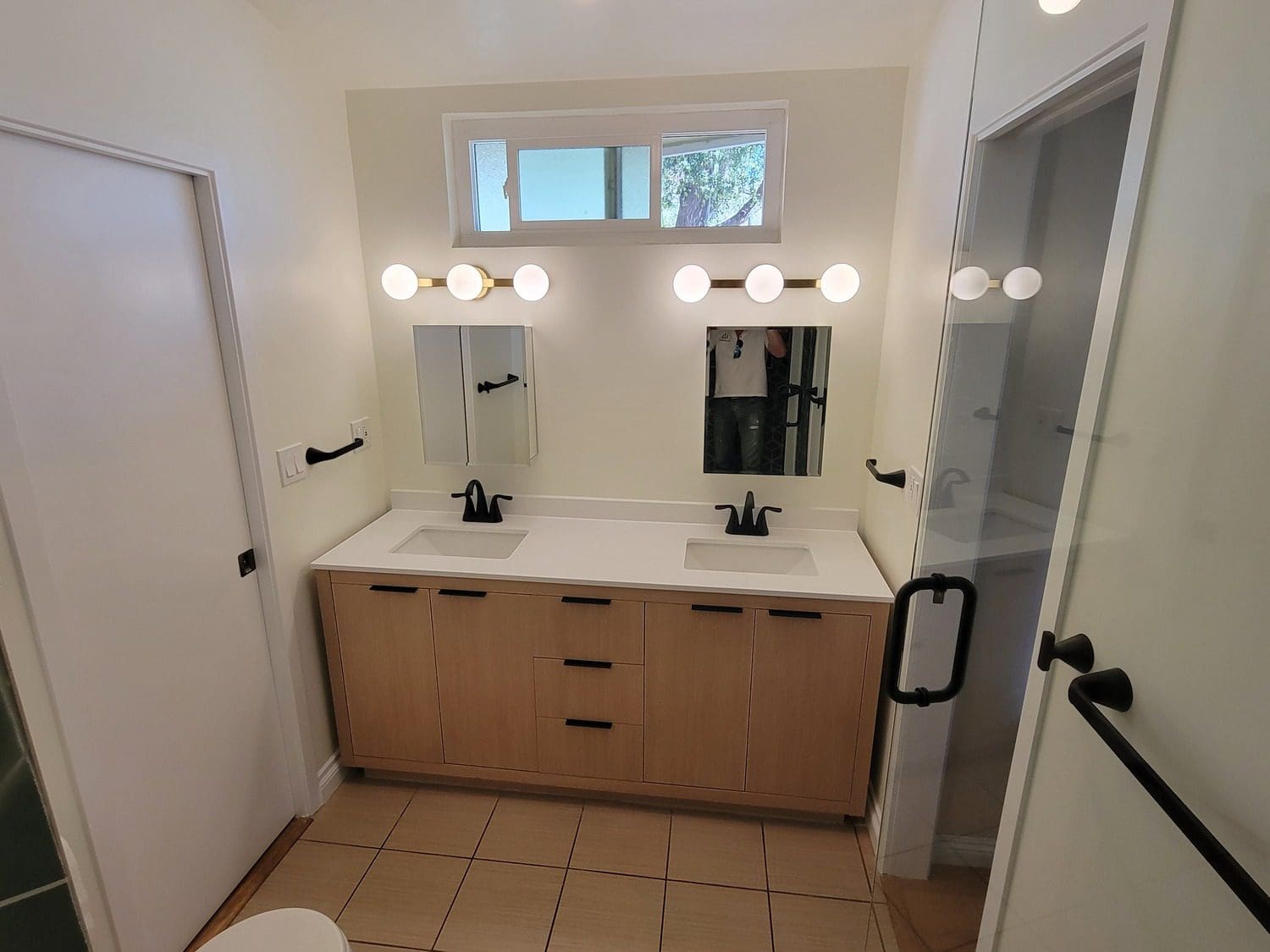 A bathroom with two sinks and mirrors.