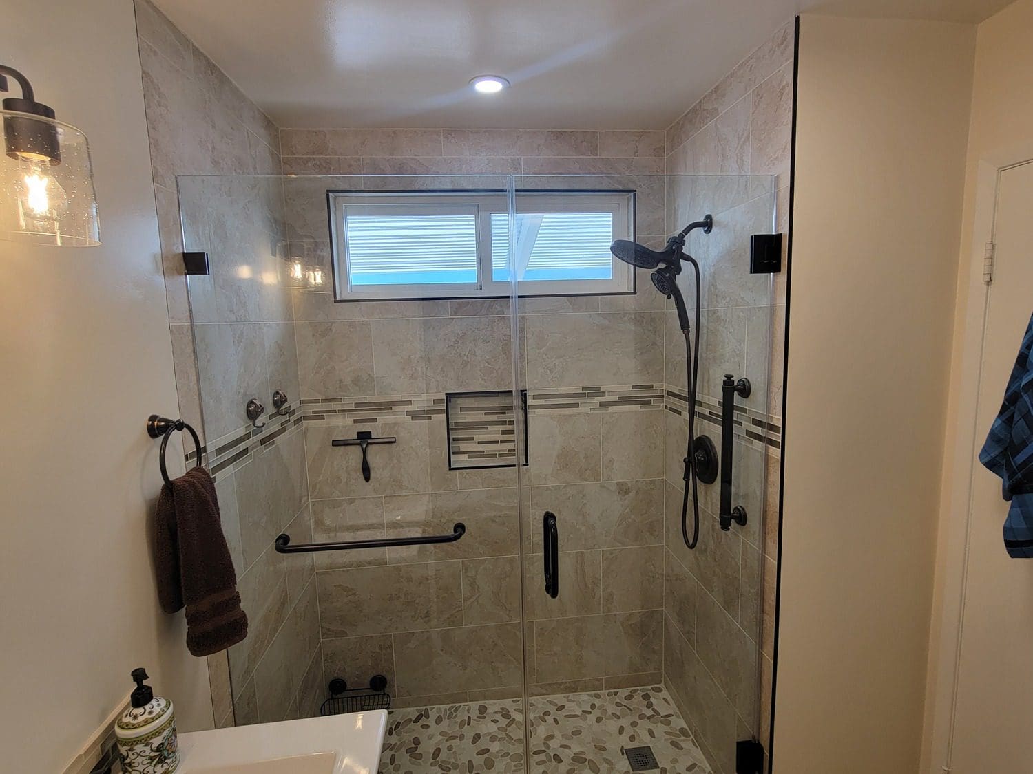 A bathroom with a shower and sink in it