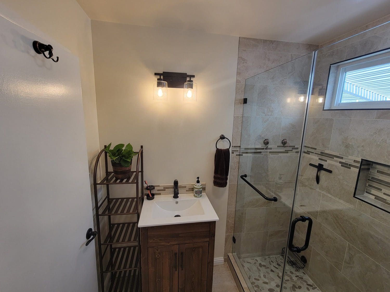 A bathroom with a sink and shower in it