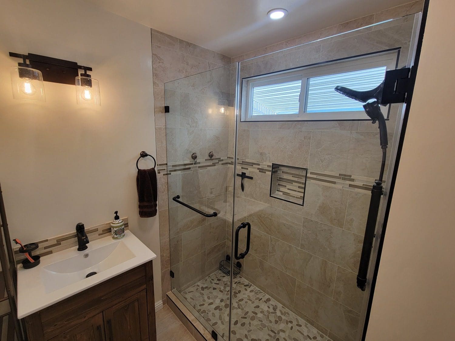 A bathroom with a sink, toilet and shower.