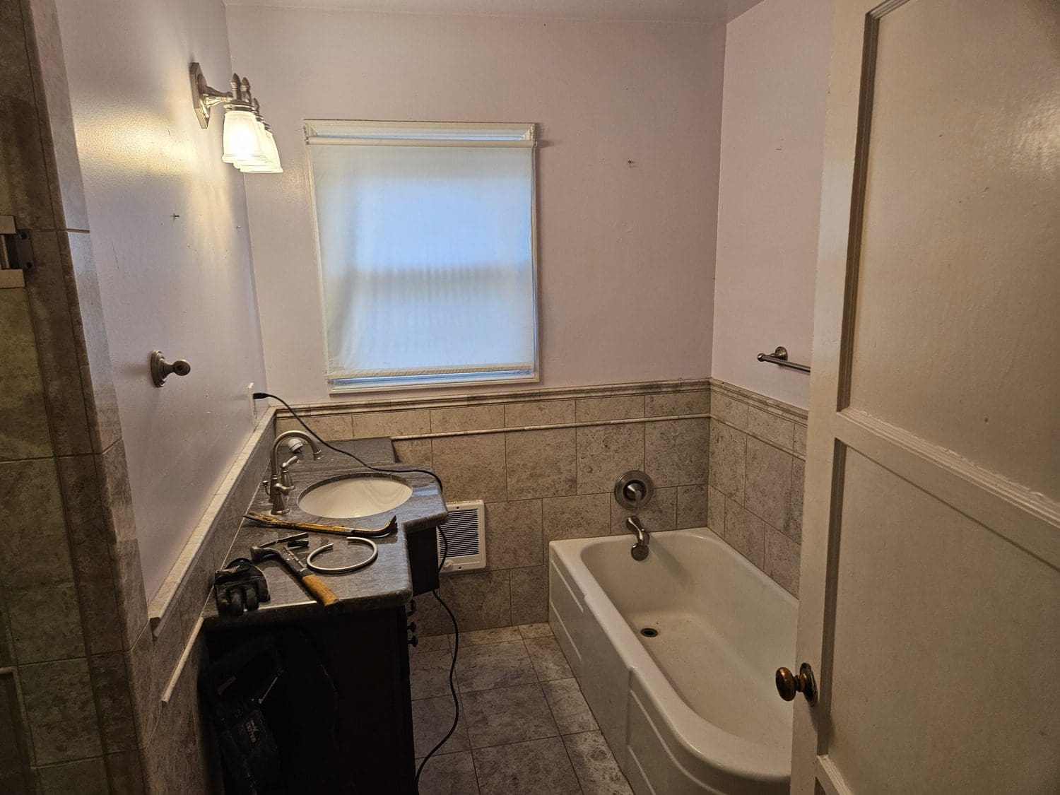 A bathroom with a sink, tub and toilet.