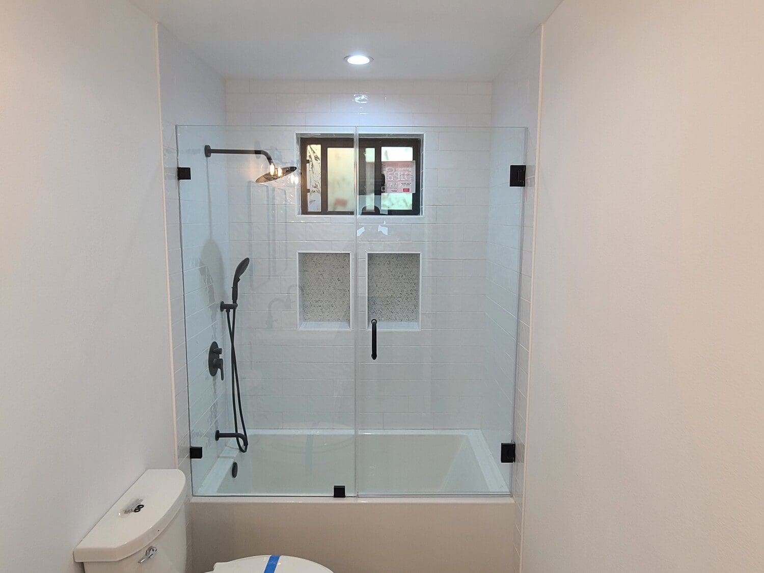 A bathroom with a tub and shower in it