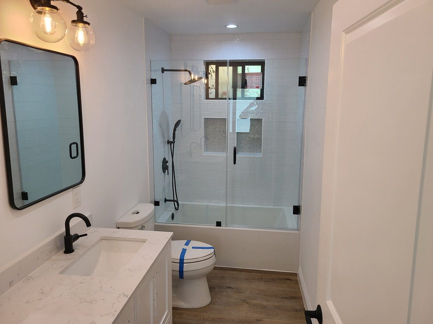 A bathroom with a toilet, sink and tub.