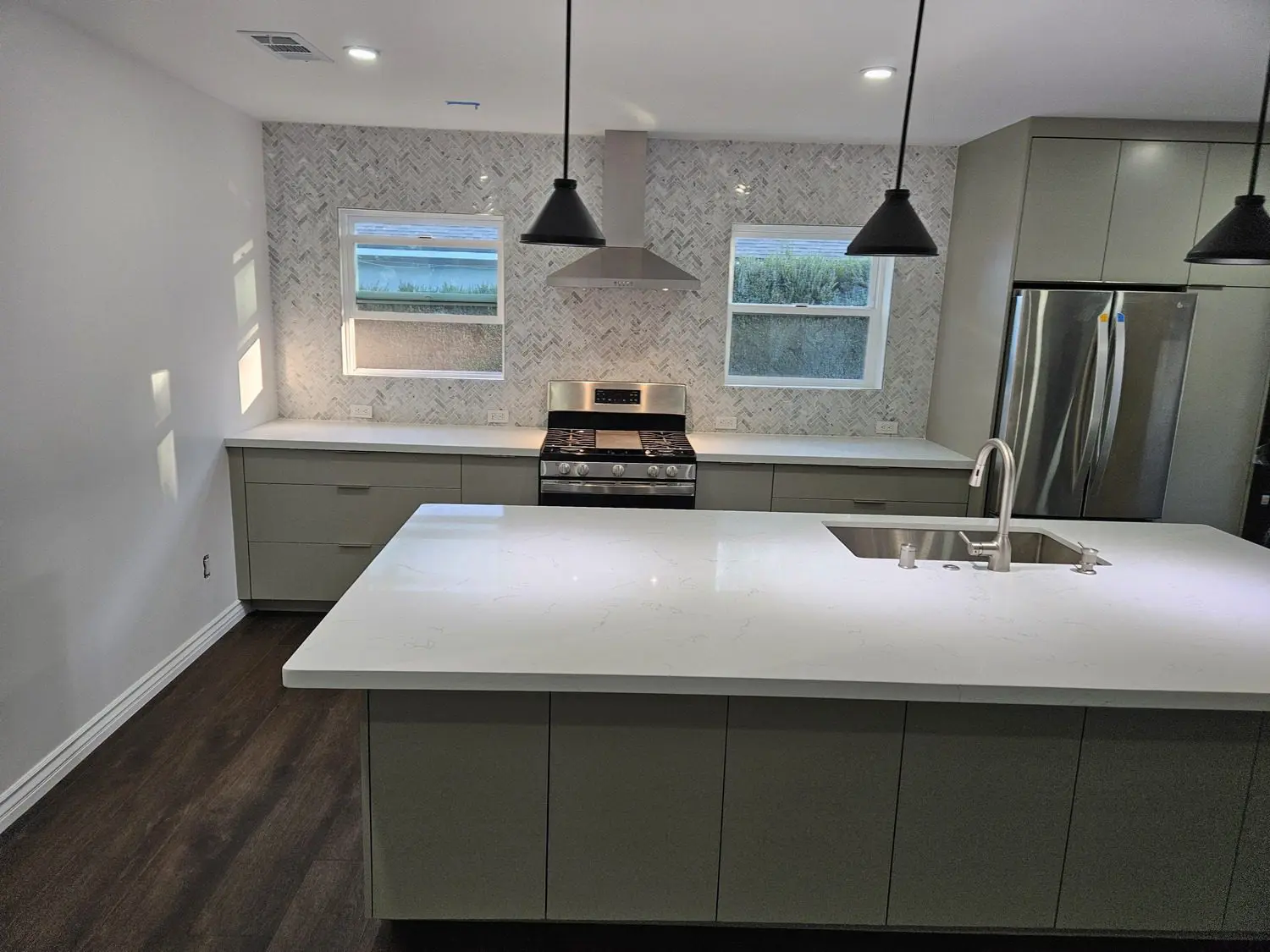 A kitchen with an island and sink in it