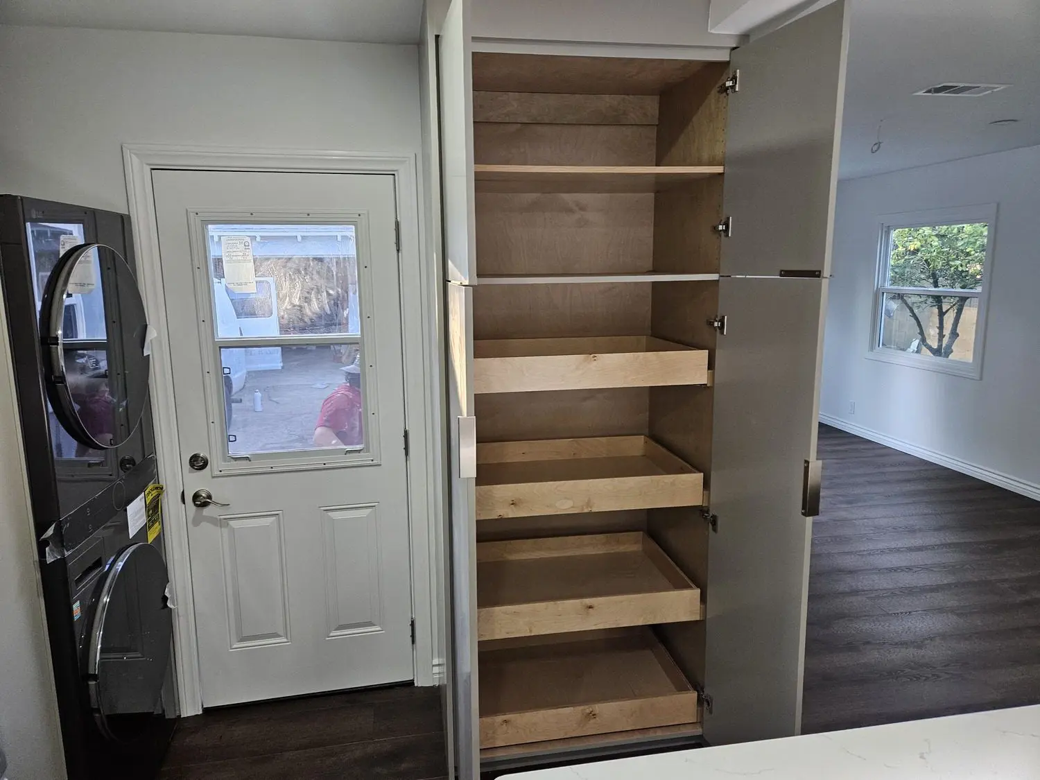 A large pantry with shelves and sliding doors.