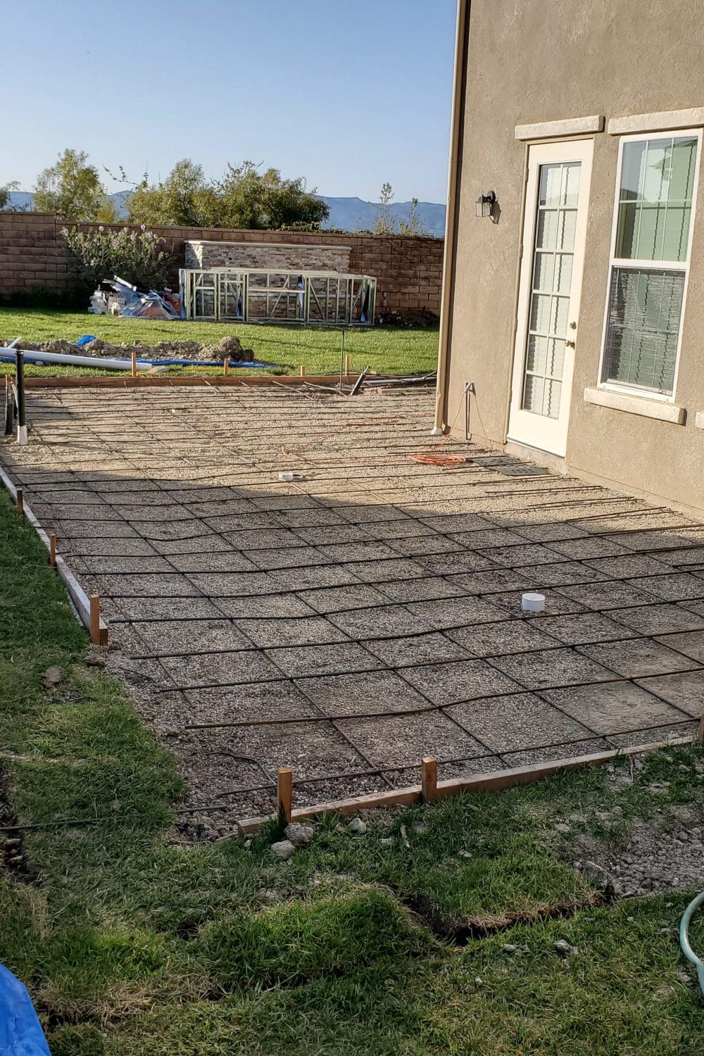 A patio with concrete slab and steel posts.