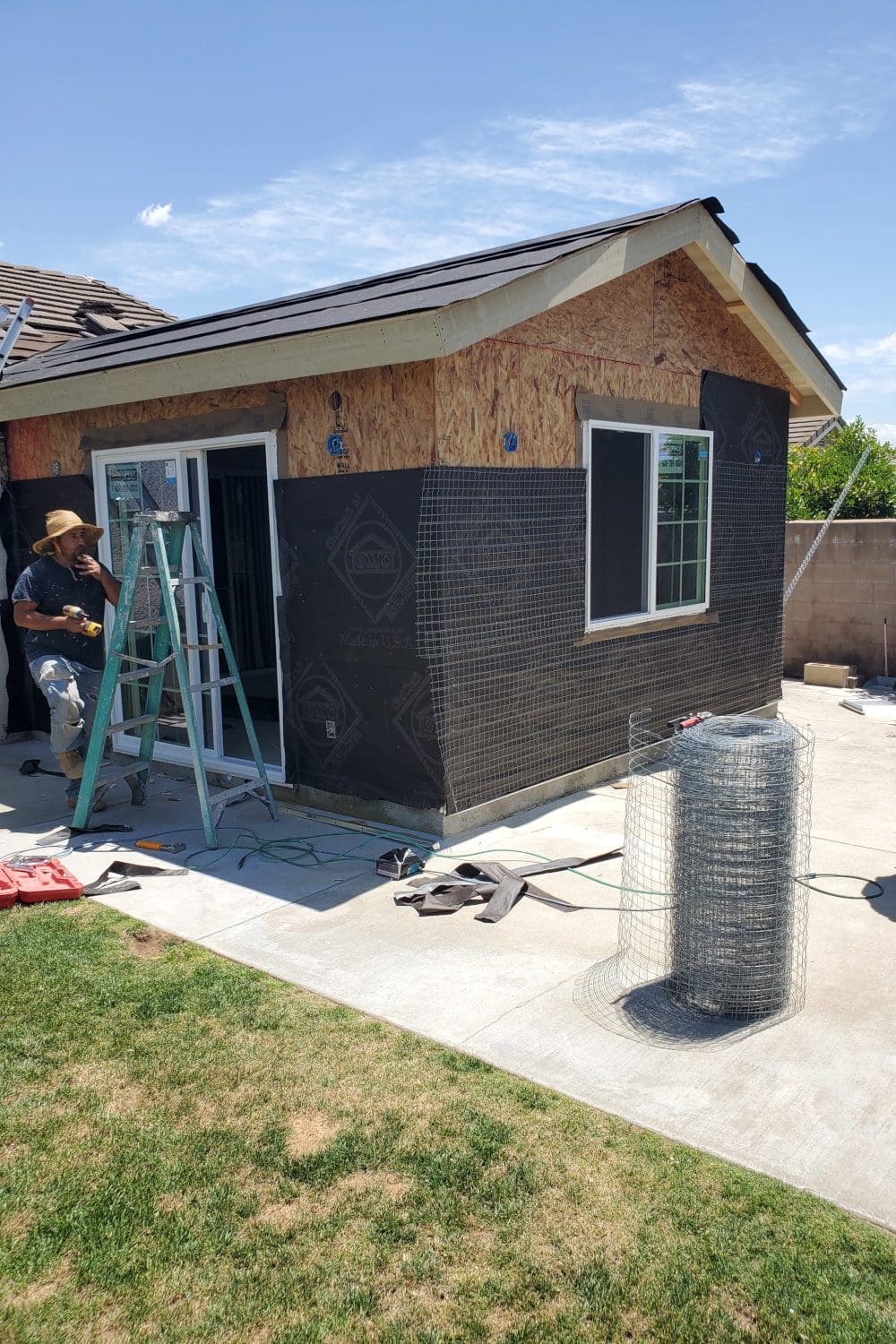 A man working on the outside of a house.