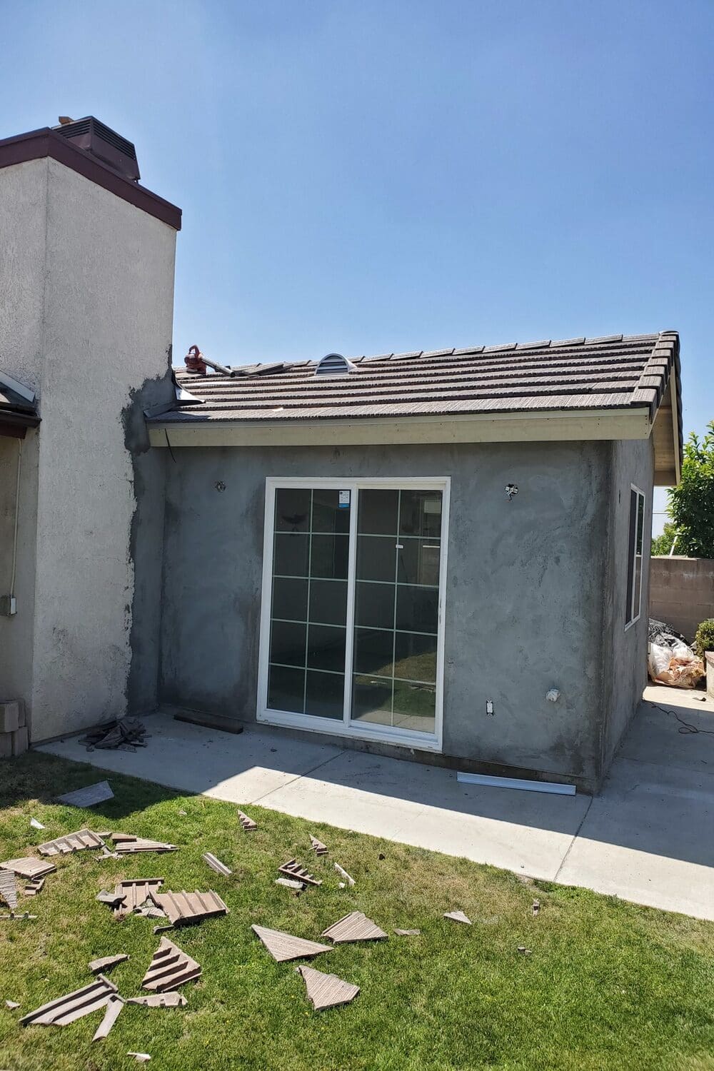 A house with a sliding glass door and a roof.