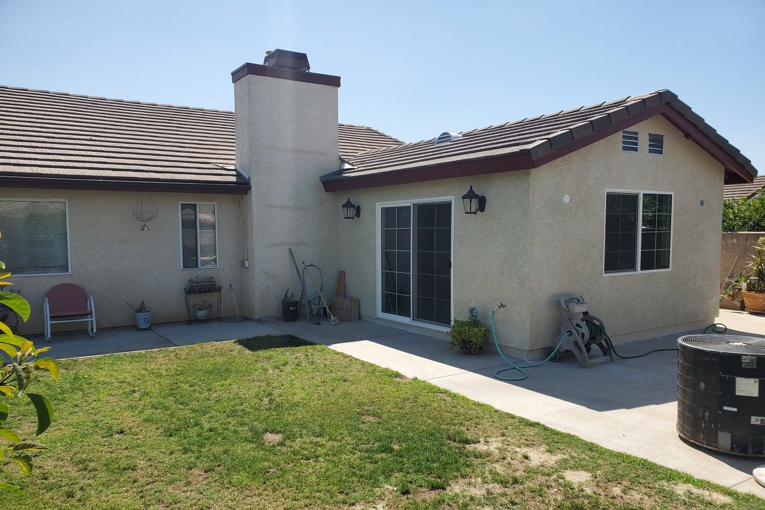 A house with a lawn and patio in it