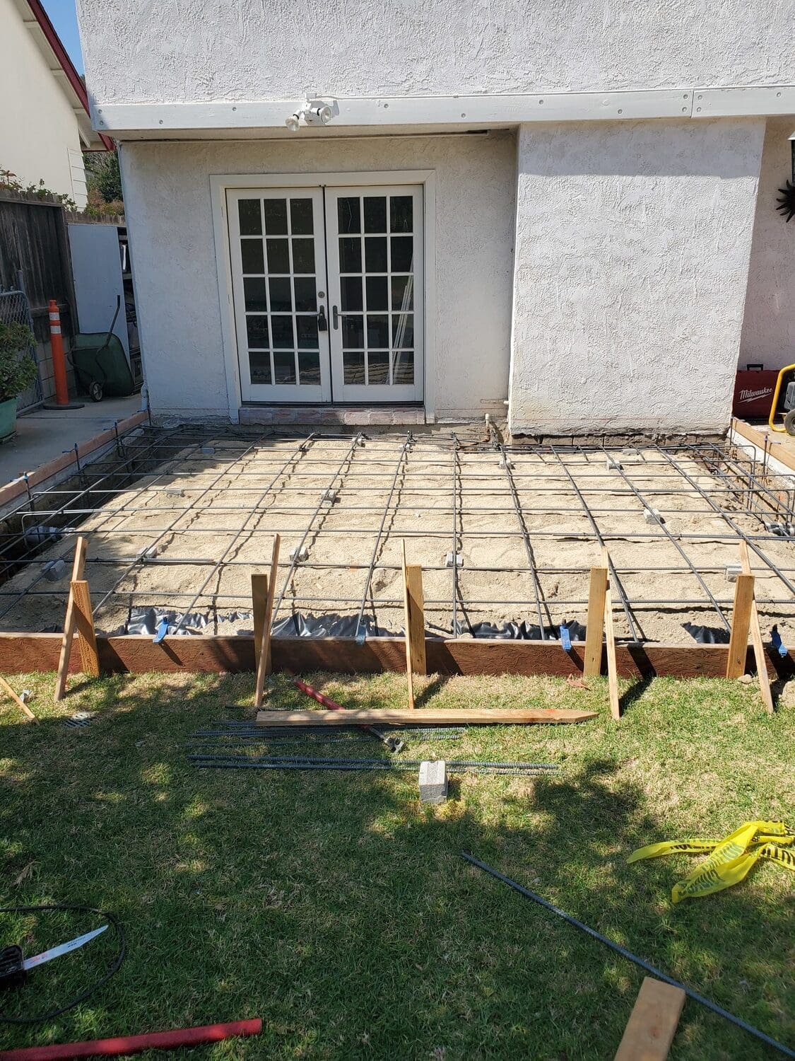 A patio being built with concrete and wood.