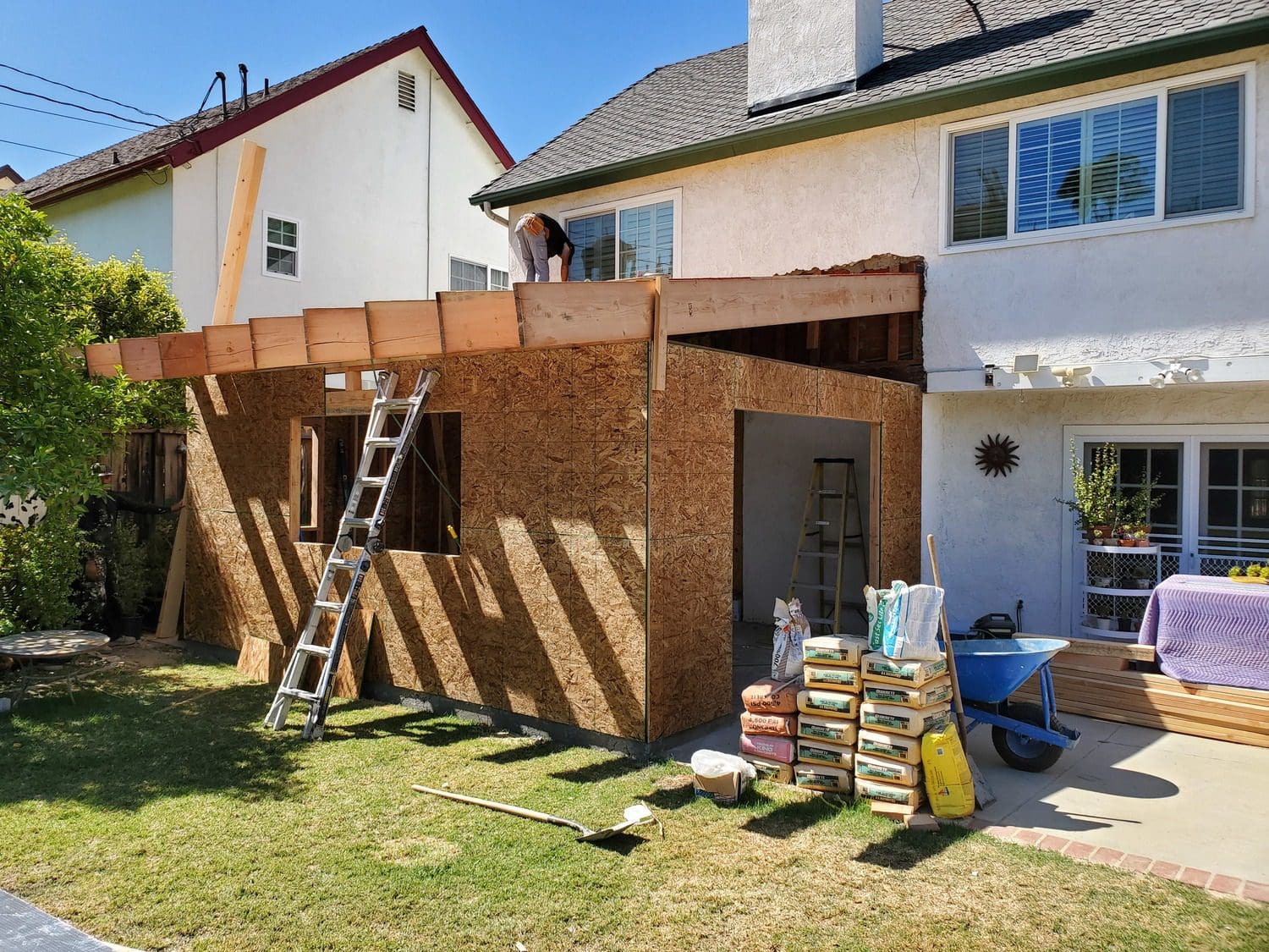 A man standing on the side of a house.