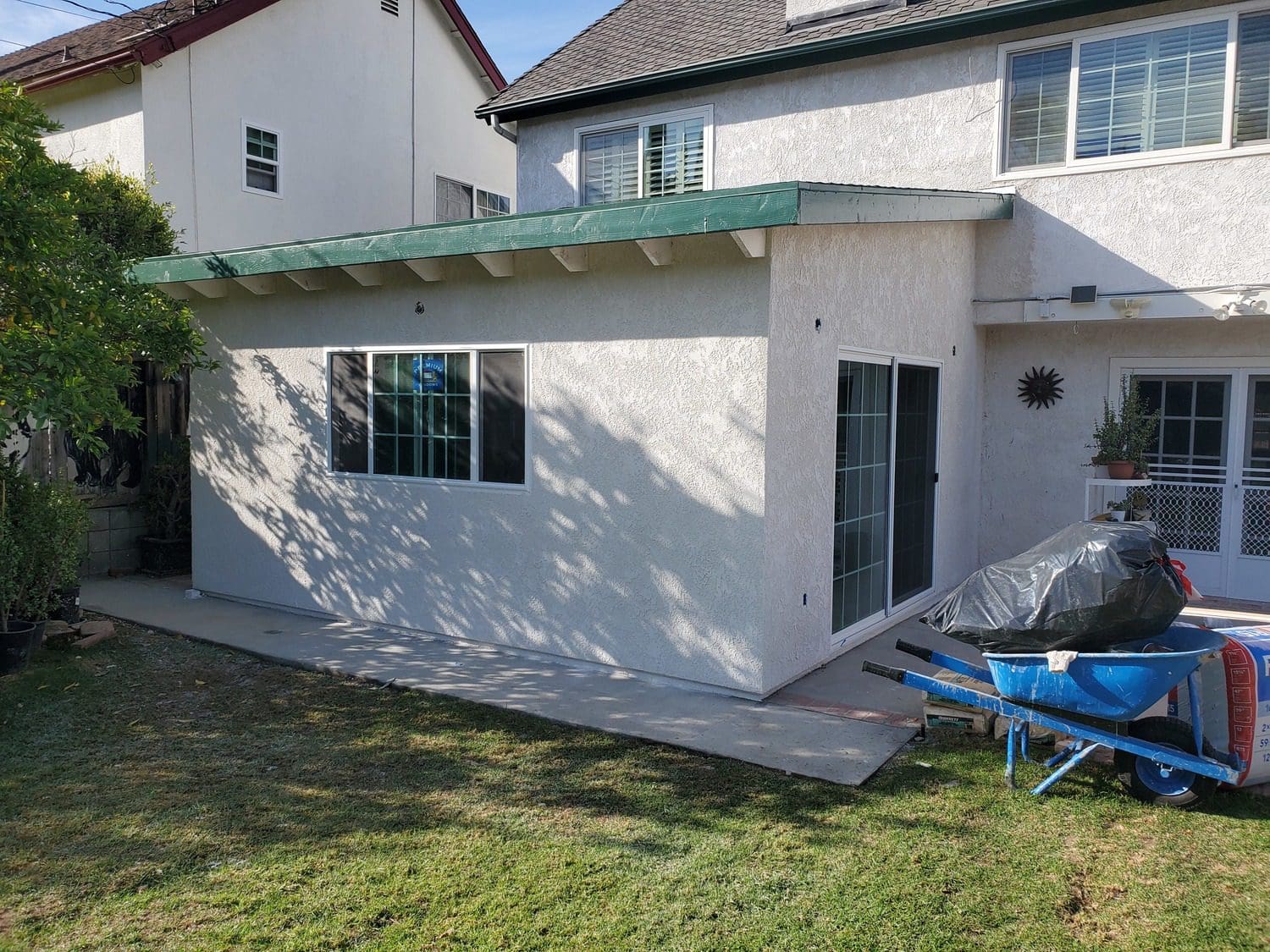 A house with a patio and lawn in it