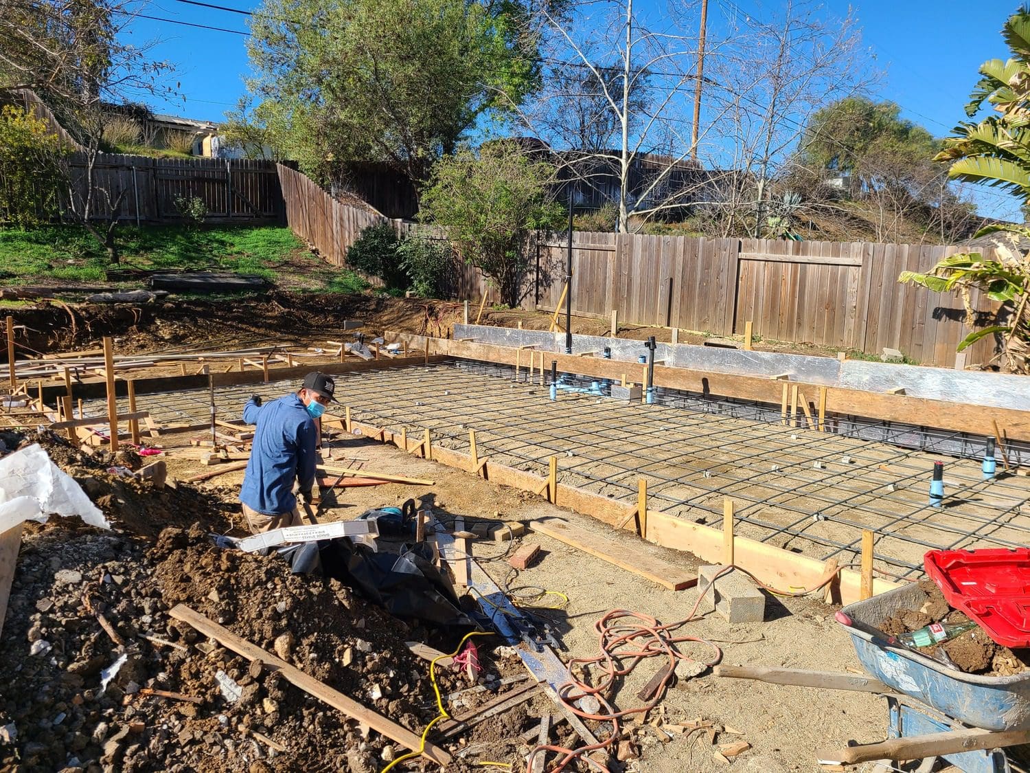 A man working on the ground in his yard.