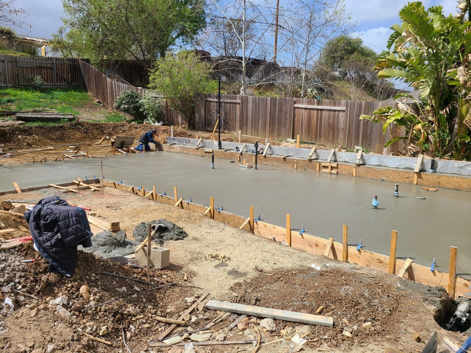 A construction site with people working on the ground.