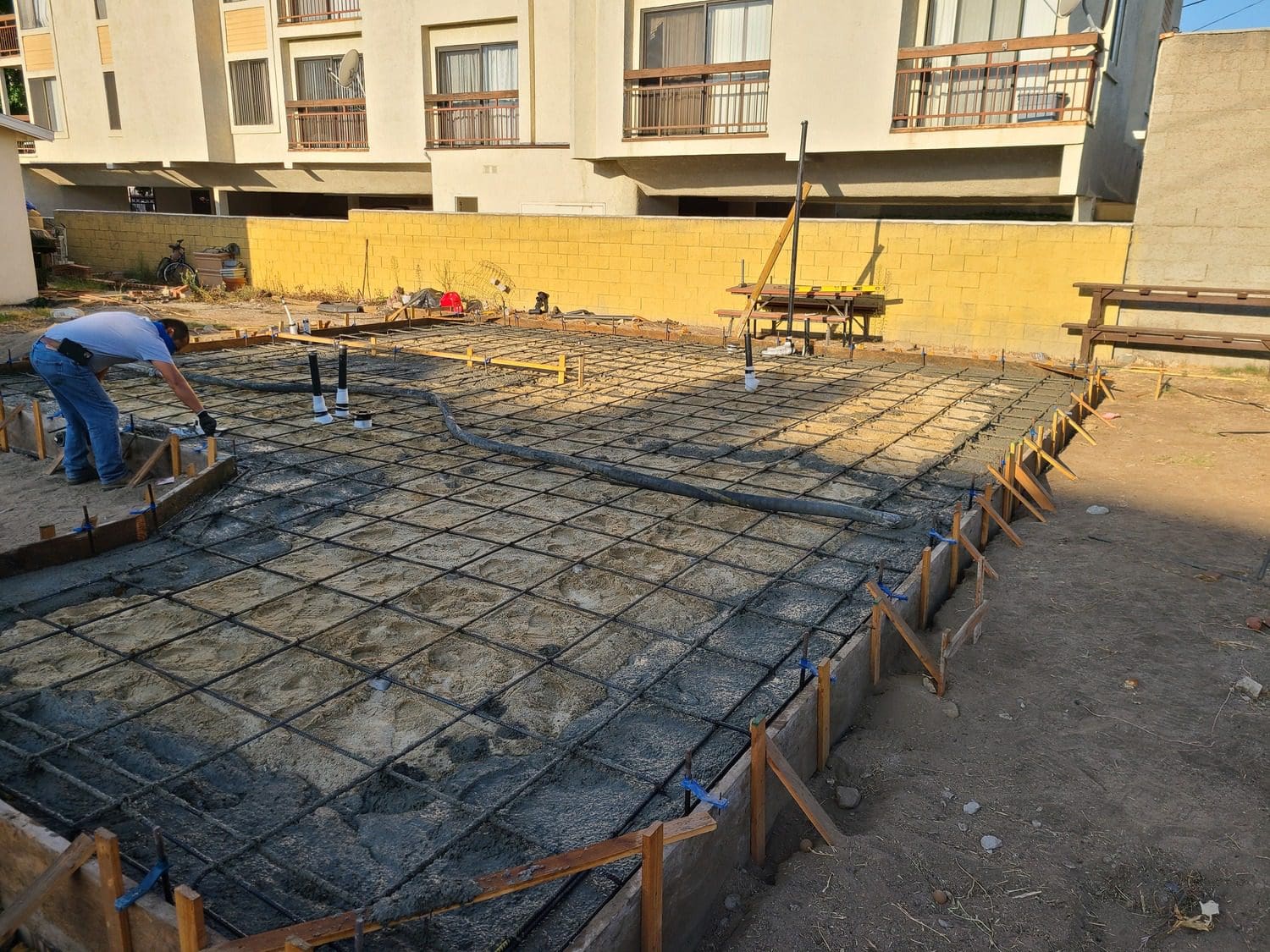 A concrete slab being poured for a building.