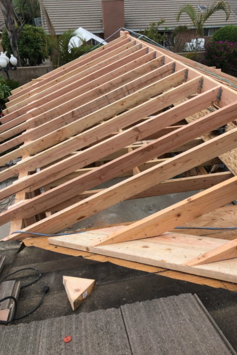 A wooden roof being built with some wood