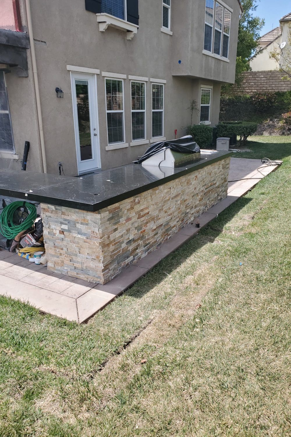 A stone wall with a black counter top