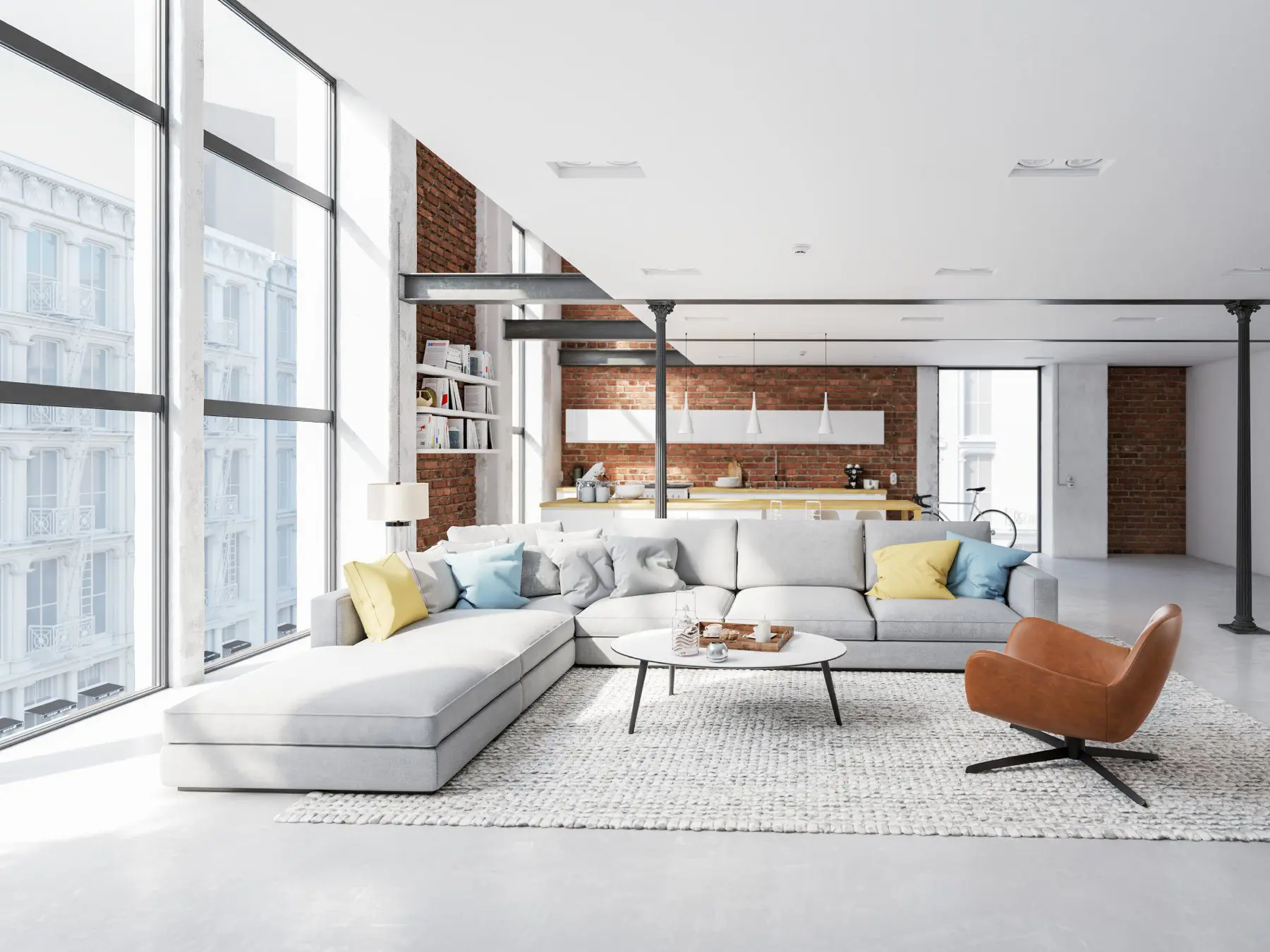 A living room with white furniture and large windows.