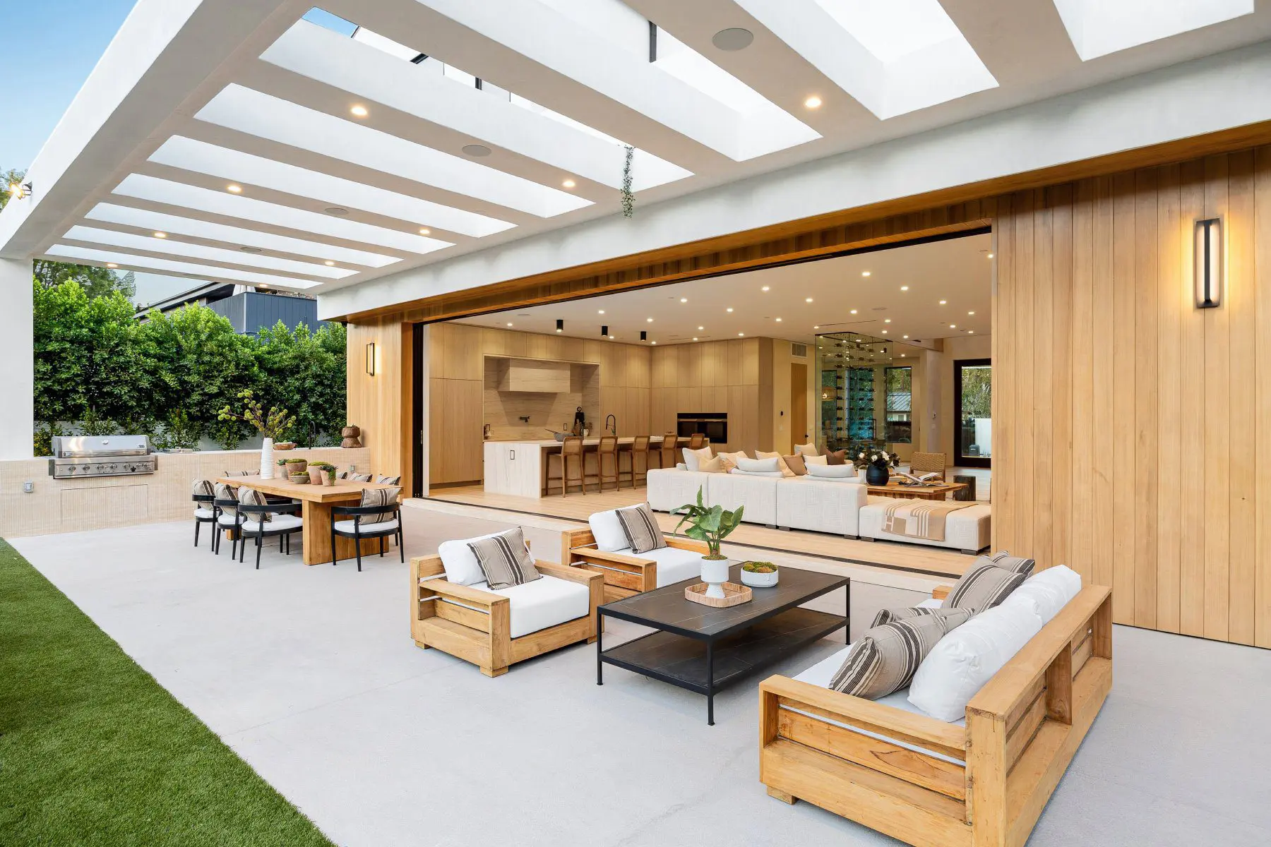 A patio with lots of furniture and a large open window.